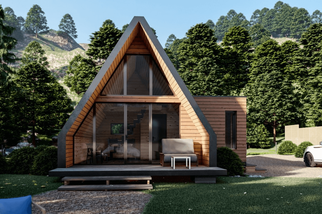 A-frame cabin with wooden exterior in a forested area, featuring a porch and glass doors.