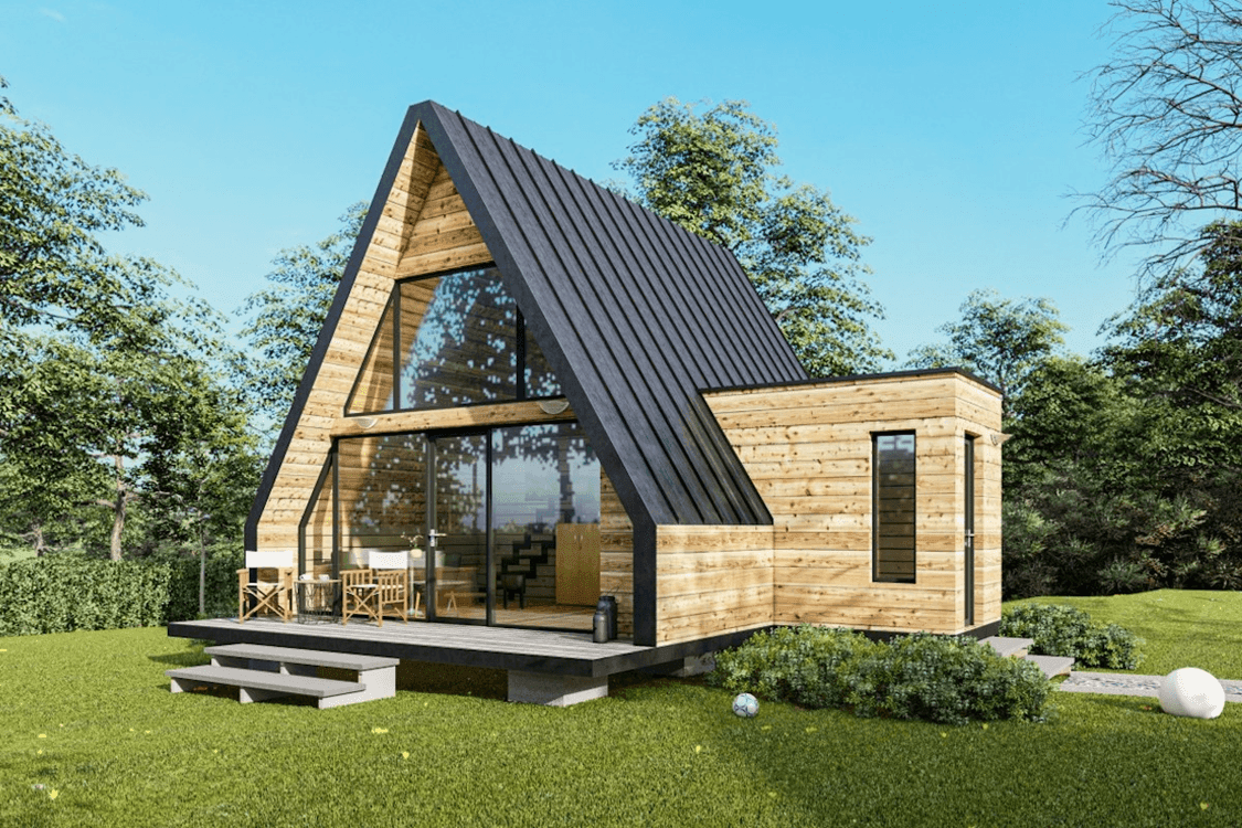 Modern wooden A-frame house with large windows set in a lush green landscape.